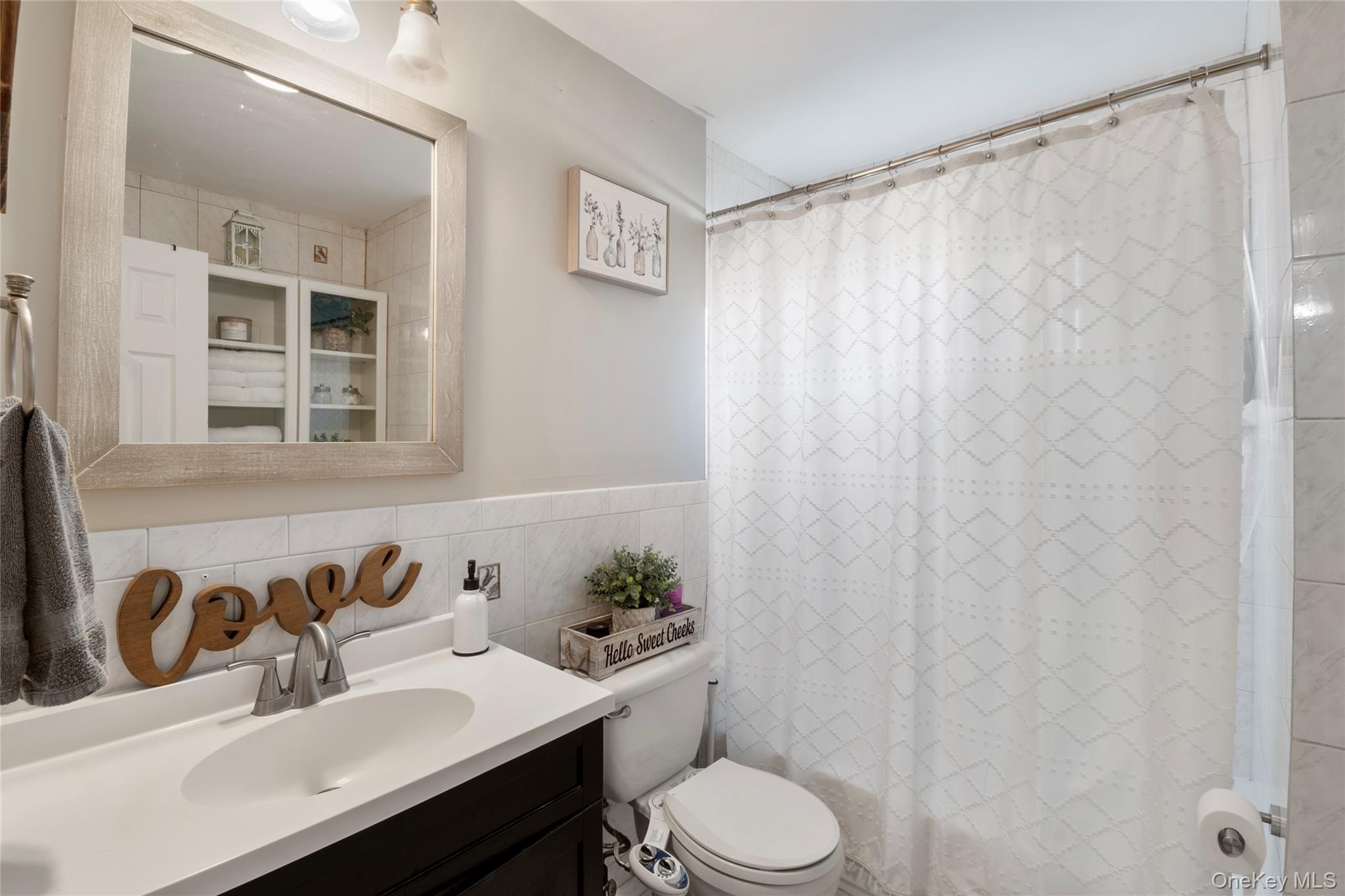 277 Horseblock Road Farmingville, NY 11738 - Photo 17 of 28 Bathroom with tile walls and vanity