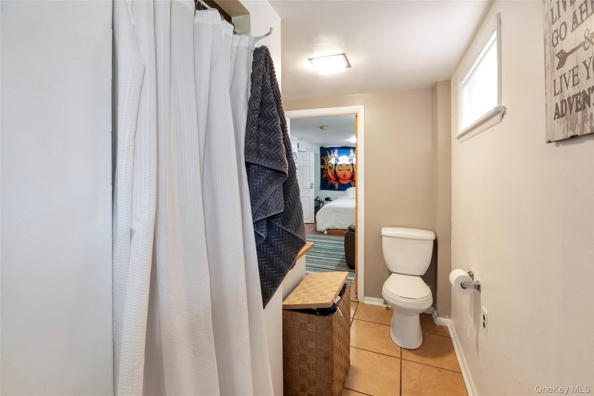 277 Horseblock Road Farmingville, NY 11738 - Photo 21 of 28 Ensuite bathroom featuring a shower with curtain and light tile patterned flooring