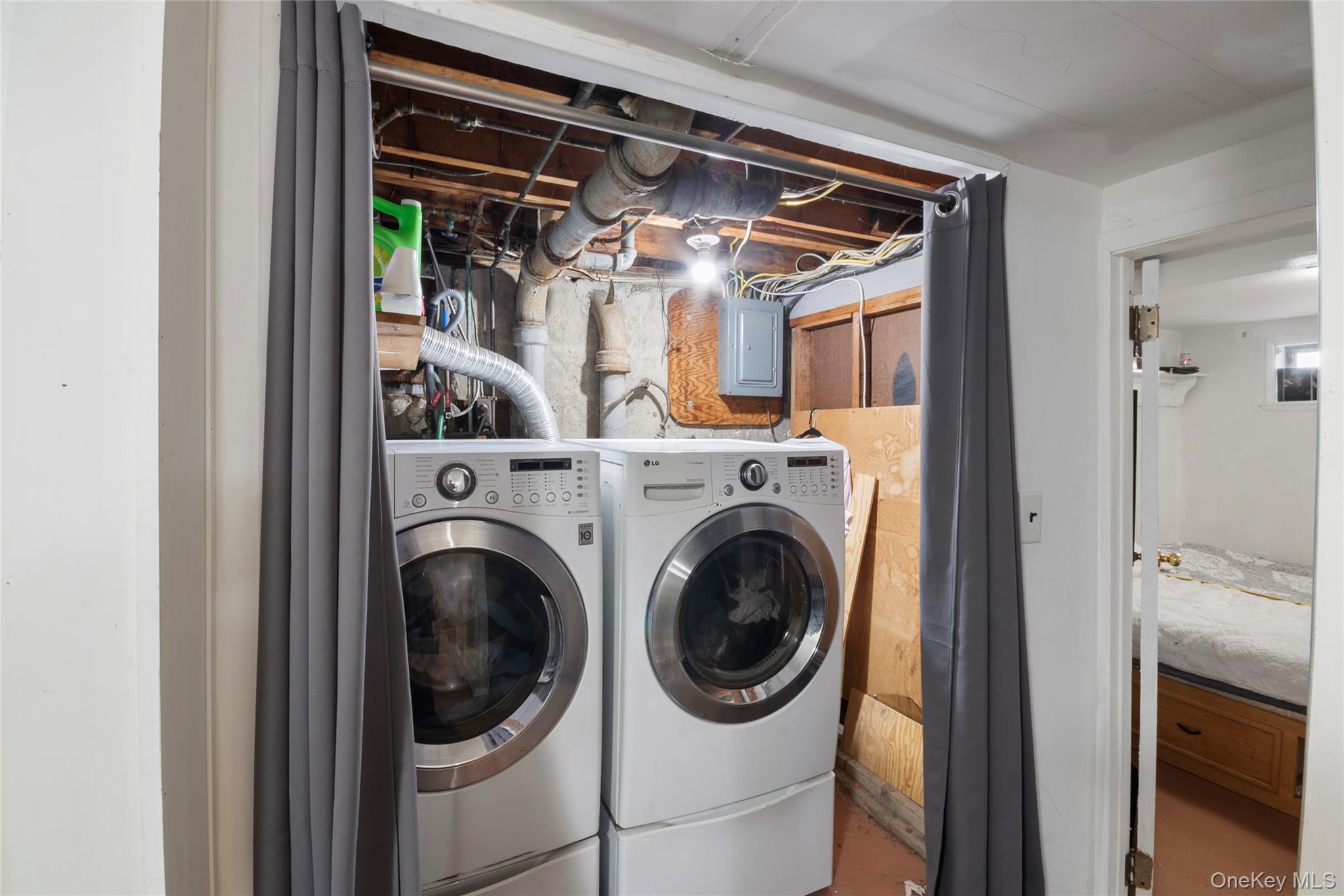 277 Horseblock Road Farmingville, NY 11738 - Photo 23 of 28 Laundry area with electric panel and independent washer and dryer