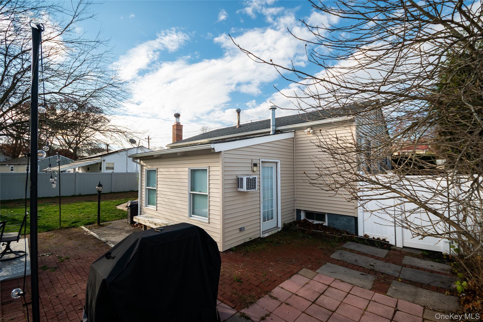 277 Horseblock Road Farmingville, NY 11738 - Photo 26 of 28 Rear view of property with a patio area and a chimney