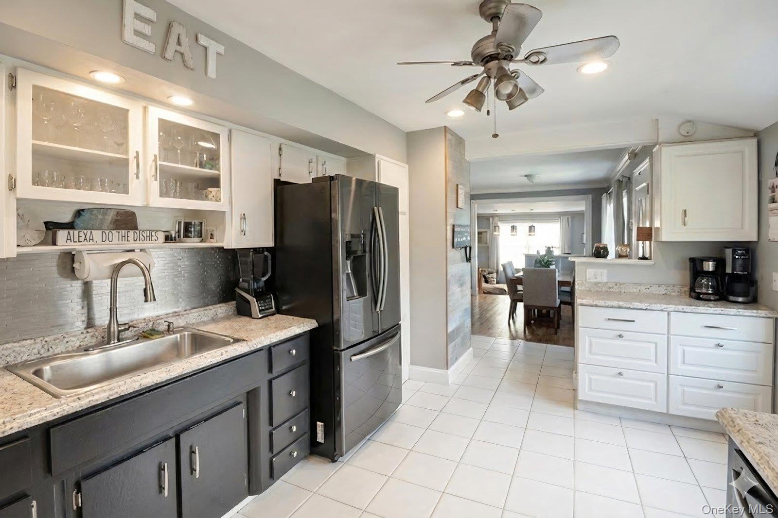 277 Horseblock Road Farmingville, NY 11738 - Photo 6 of 28 Kitchen featuring white cabinetry, stainless steel fridge with ice dispenser, glass insert cabinets, a ceiling fan, and light tile patterned flooring