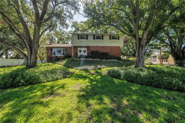 a view of backyard of house with green space