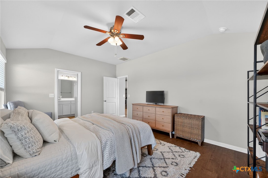 201 Cane River Road Pflugerville, TX 78660 - Photo 11 of 21 a bedroom with a bed and a chandelier