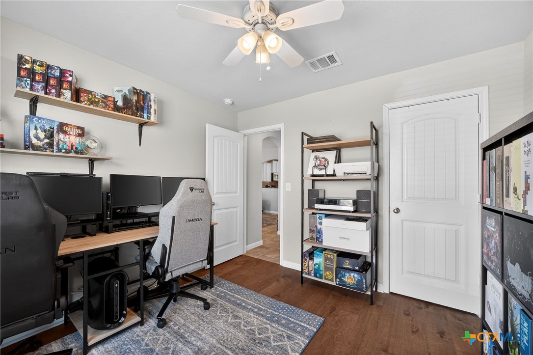 201 Cane River Road Pflugerville, TX 78660 - Photo 12 of 21 a view of a workspace with furniture and wooden floor