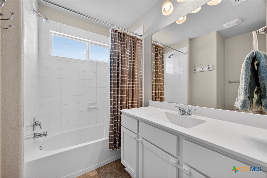 201 Cane River Road Pflugerville, TX 78660 - Photo 13 of 21 a bathroom with a tub sink and mirror