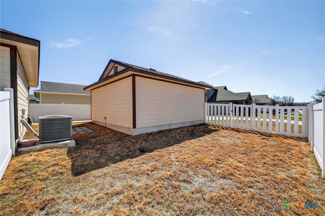 201 Cane River Road Pflugerville, TX 78660 - Photo 16 of 21 a backyard of a house with wooden floor and fence