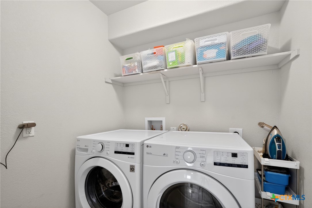 201 Cane River Road Pflugerville, TX 78660 - Photo 17 of 21 a utility room with dryer and washer