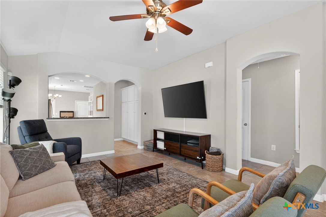 201 Cane River Road Pflugerville, TX 78660 - Photo 2 of 21 a living room with furniture and a flat screen tv