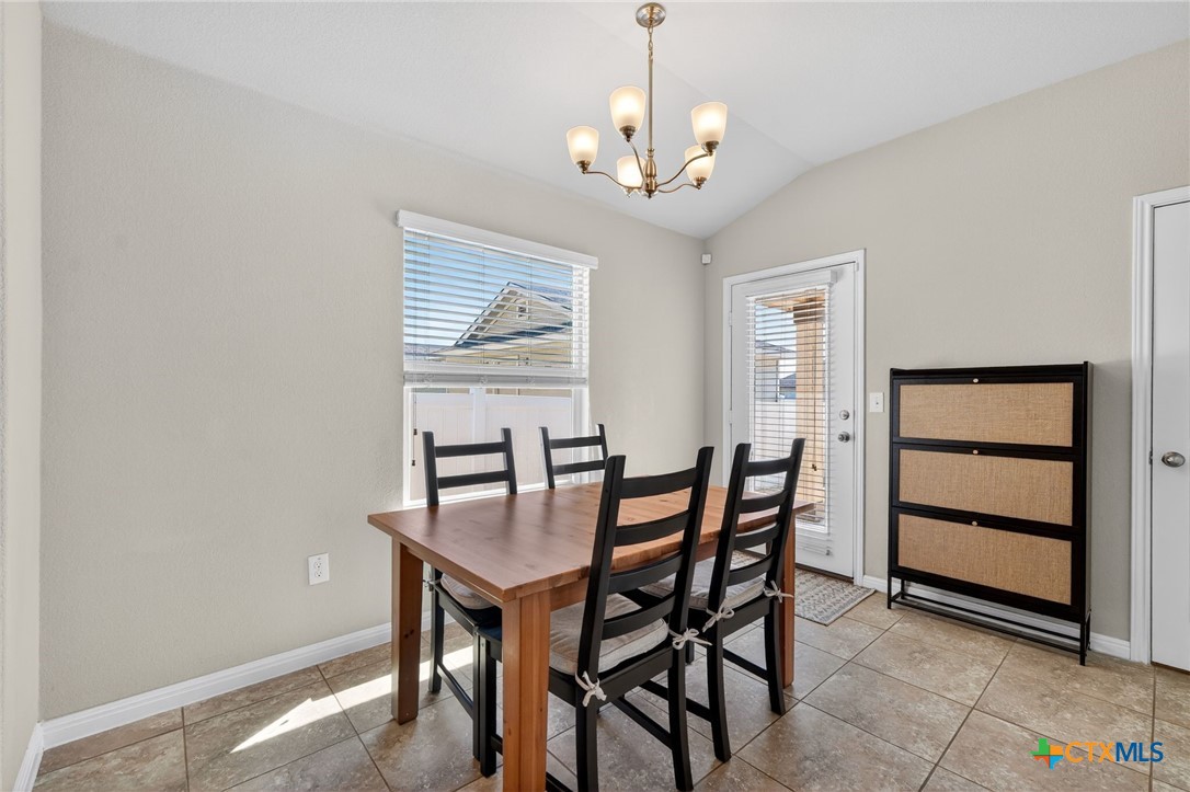 201 Cane River Road Pflugerville, TX 78660 - Photo 4 of 21 a view of a dining room with furniture and wooden floor