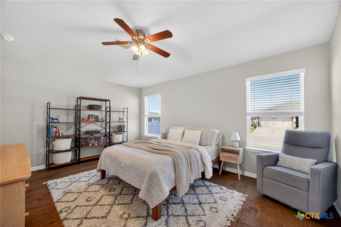 201 Cane River Road Pflugerville, TX 78660 - Photo 9 of 21 a bedroom with a bed and a couch