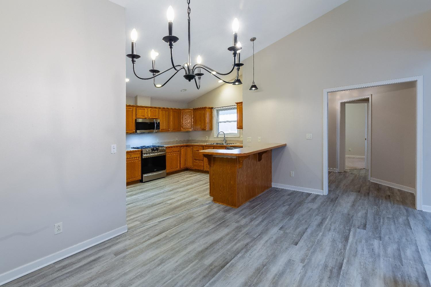 406 Pheasant Run Rensselaer, IN 47978 - Photo 26 of 37 a view of a kitchen counter space a sink a window and wooden floor