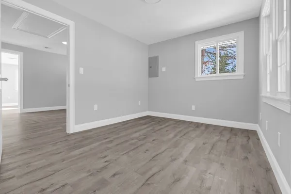 wooden floor in an empty room with a window