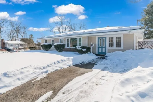 a view of a house with a yard covered in snow