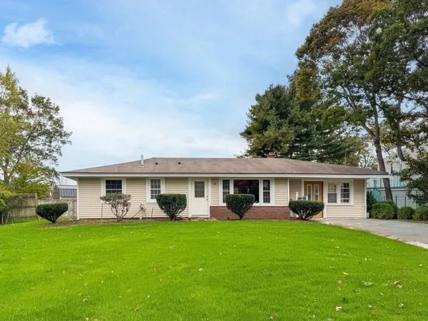 a front view of a house with a yard table and chairs