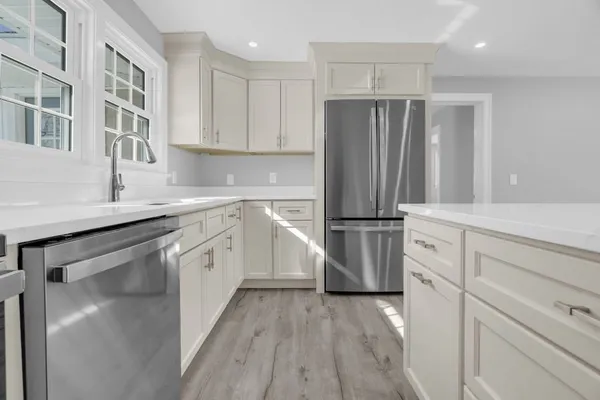 a kitchen with stainless steel appliances a refrigerator sink and cabinets