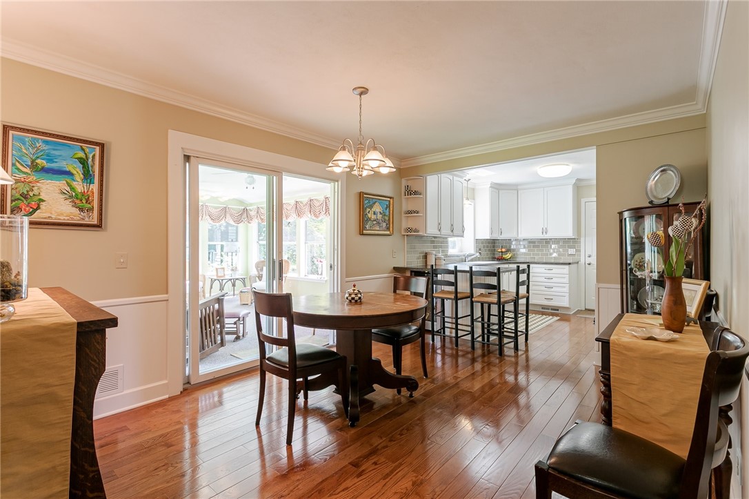 2024 Baird Road Penfield, NY 14526 - Photo 17 of 37 Kitchen and dining spaces and sliding doors leadin