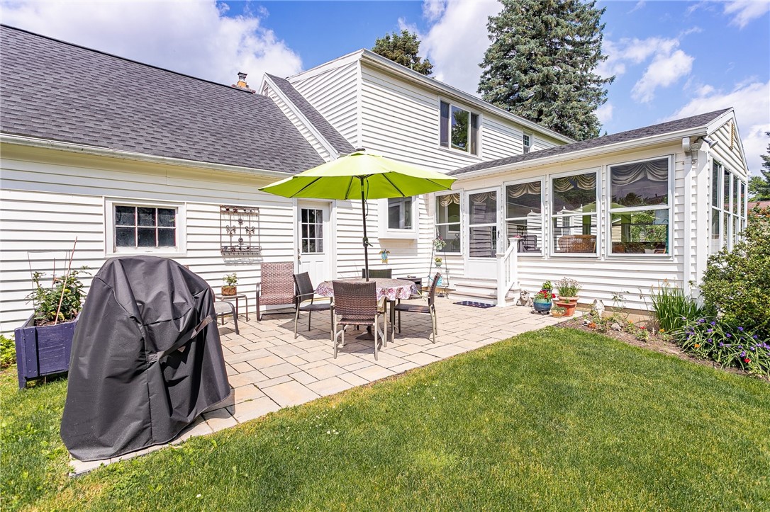 2024 Baird Road Penfield, NY 14526 - Photo 26 of 37 Entertaining is easy with this large paver patio a