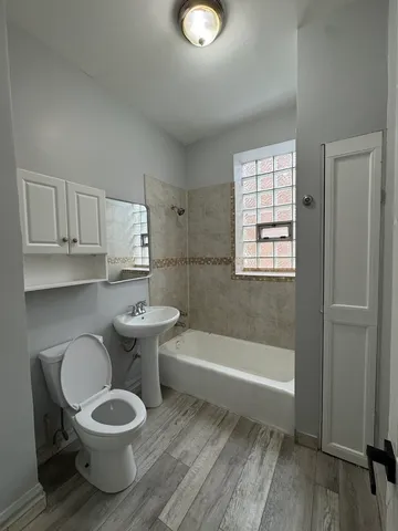 a bathroom with a sink a toilet and bathtub
