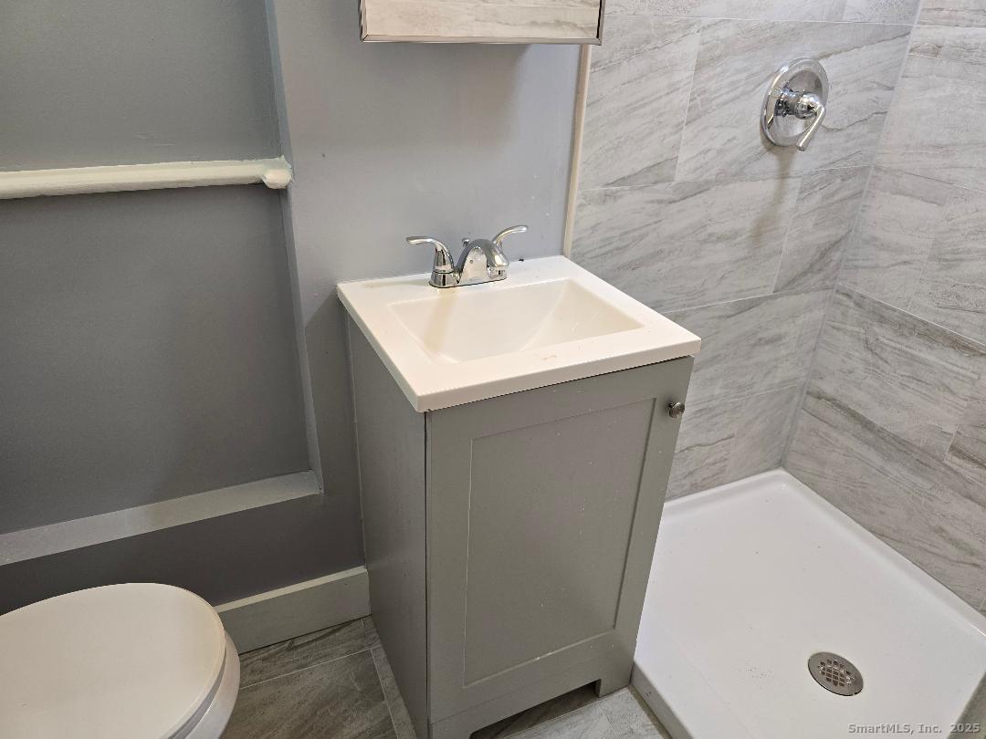 22 East Dover Street, Unit B Waterbury, CT 06706 - Photo 4 of 5 a bathroom with a sink and toilet