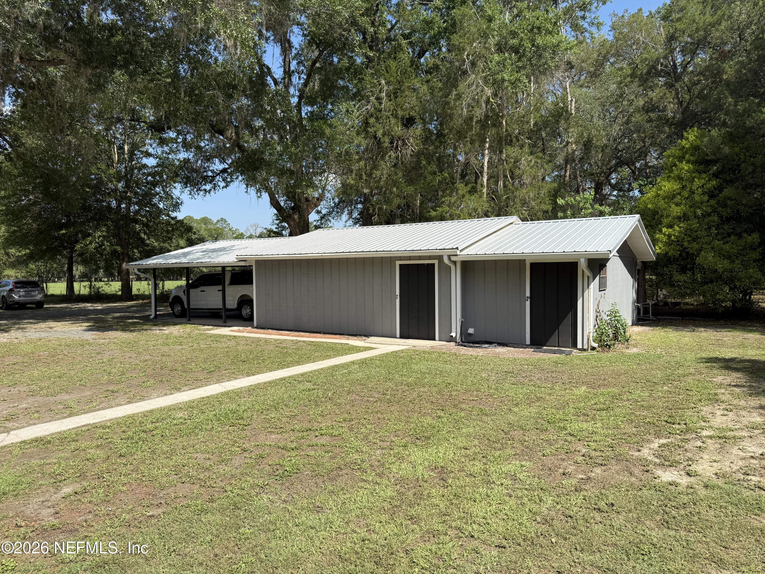 13733 John Williams Road Sanderson, FL 32087 - Photo 26 of 73 a front view of a house with a yard and garage