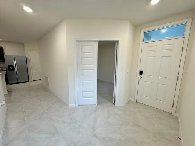 an empty room with closet and mirrors