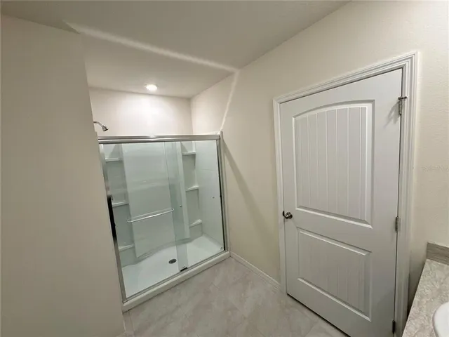 a bathroom with a glass shower door