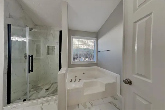 a bathroom with a bathtub and shower