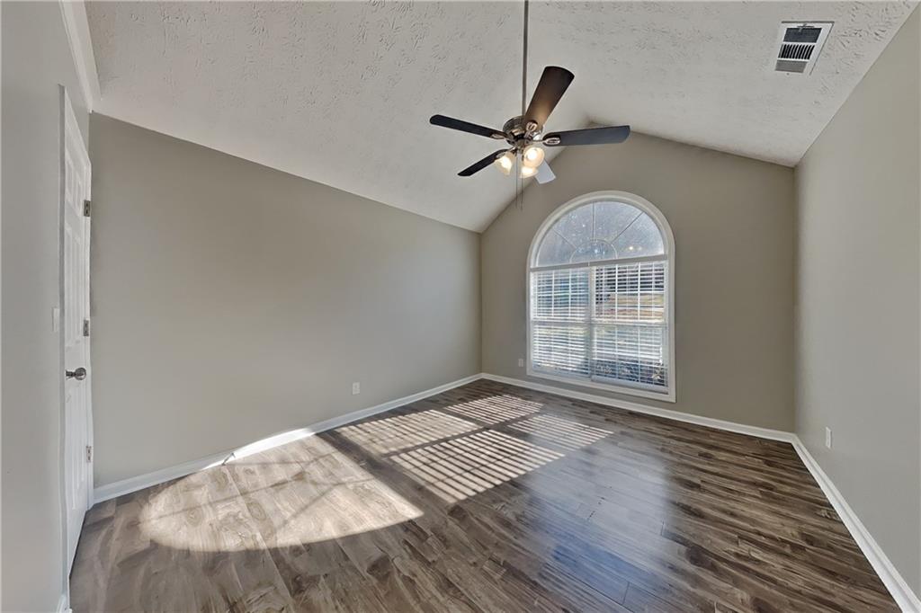 3845 Rajean Drive Lawrenceville, GA 30044 - Photo 14 of 18 a view of an empty room with wooden floor and a window