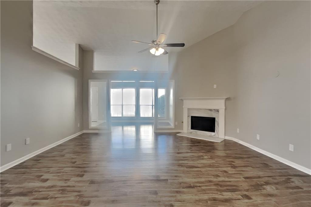 3845 Rajean Drive Lawrenceville, GA 30044 - Photo 2 of 18 a view of empty room with wooden floor and fireplace