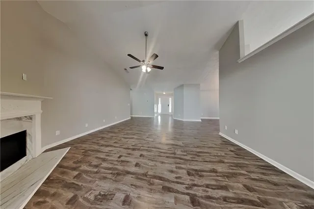 wooden floor in an empty room with a fireplace