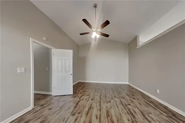 a view of an empty room with wooden floor