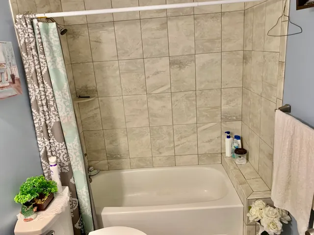 a bathroom with a bathtub and shower