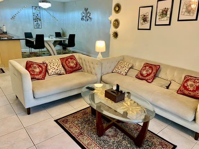 a living room with furniture and painting on the wall