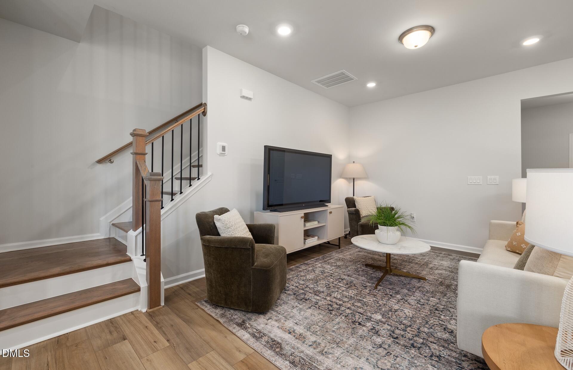 2818 Rodeo Court Fuquay-Varina, NC 27526 - Photo 13 of 30 a living room with furniture and a flat screen tv