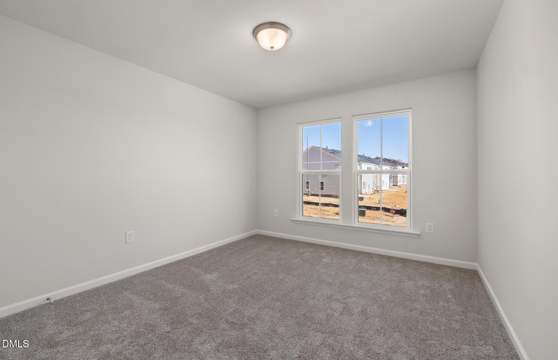 2818 Rodeo Court Fuquay-Varina, NC 27526 - Photo 21 of 30 an empty room with windows and view of kitchen
