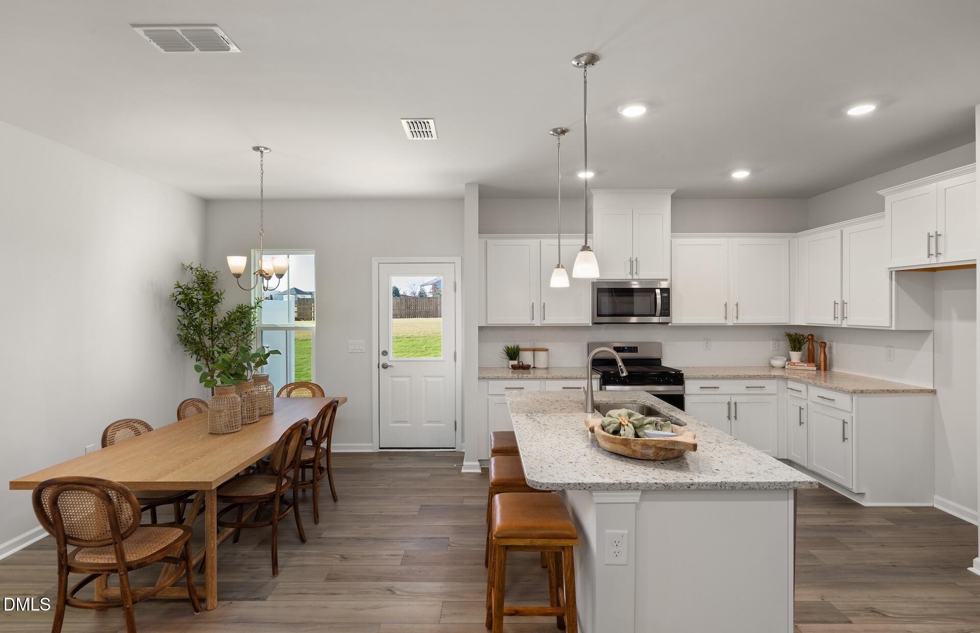 2818 Rodeo Court Fuquay-Varina, NC 27526 - Photo 8 of 30 a kitchen that has a table and chairs in it