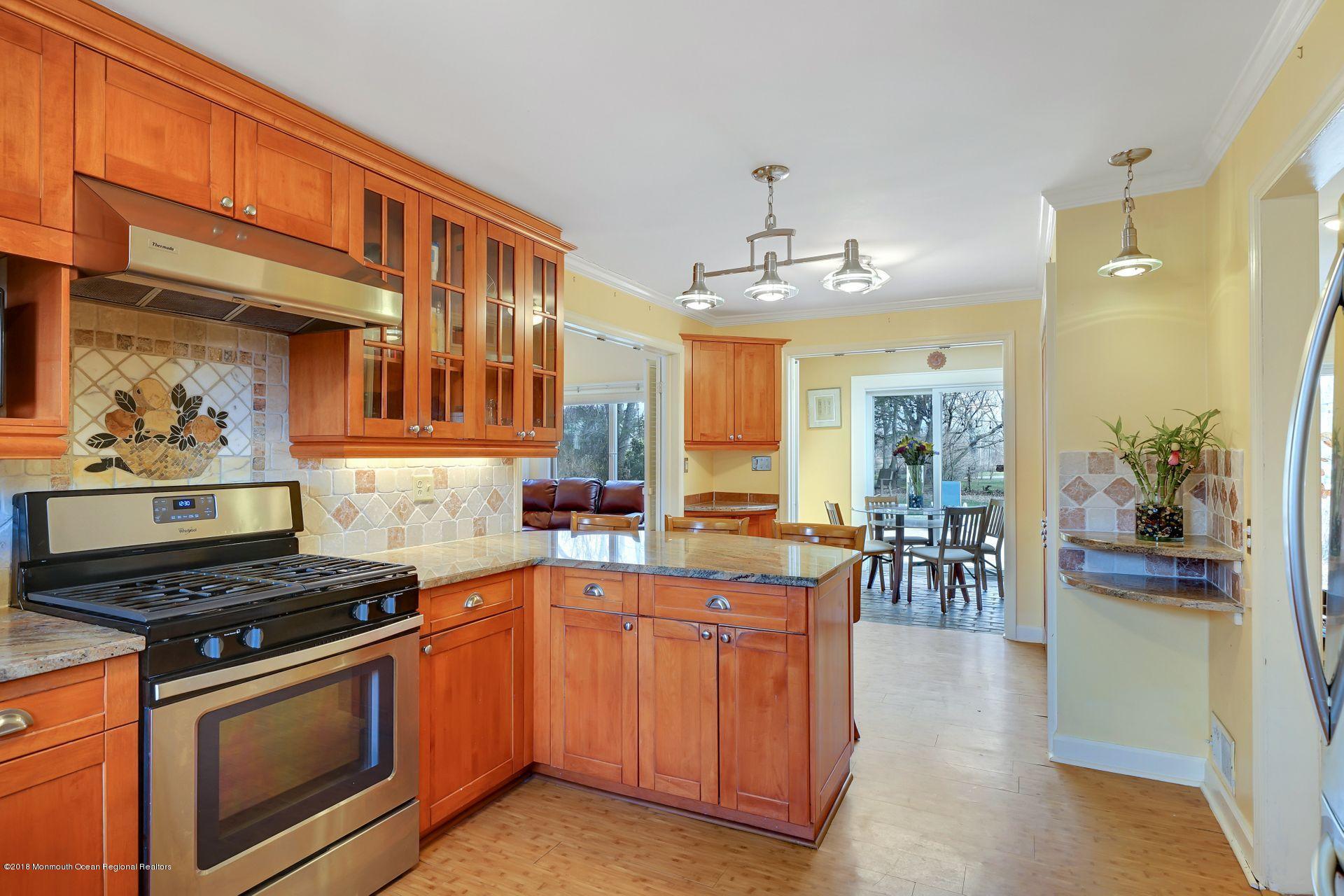 11 Heathcliff Road Rumson, NJ 07760 - Photo 19 of 31 a kitchen with stainless steel appliances a stove a sink dishwasher and cabinets with wooden floor