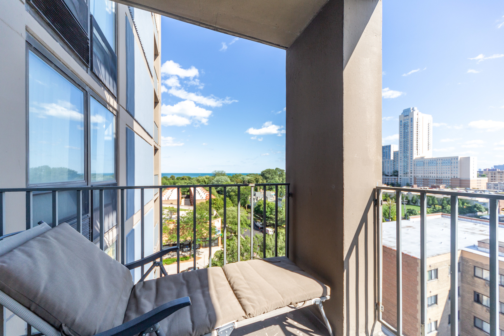 5320 North Sheridan Road, Unit 802 Chicago, IL 60640 - Photo 19 of 26 a view of a balcony with furniture and a floor to ceiling window