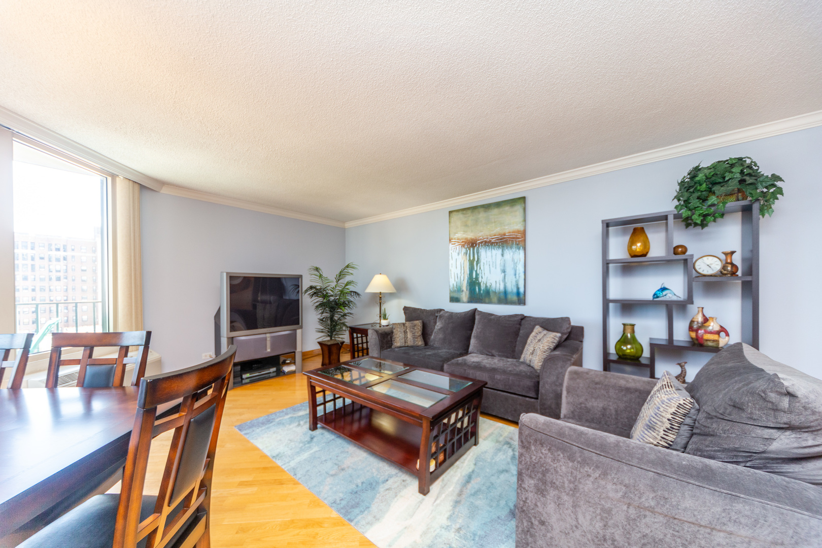 5320 North Sheridan Road, Unit 802 Chicago, IL 60640 - Photo 3 of 26 a living room with furniture and a flat screen tv