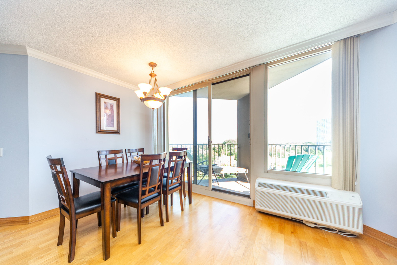 5320 North Sheridan Road, Unit 802 Chicago, IL 60640 - Photo 5 of 26 a dining room with furniture and a floor to ceiling window