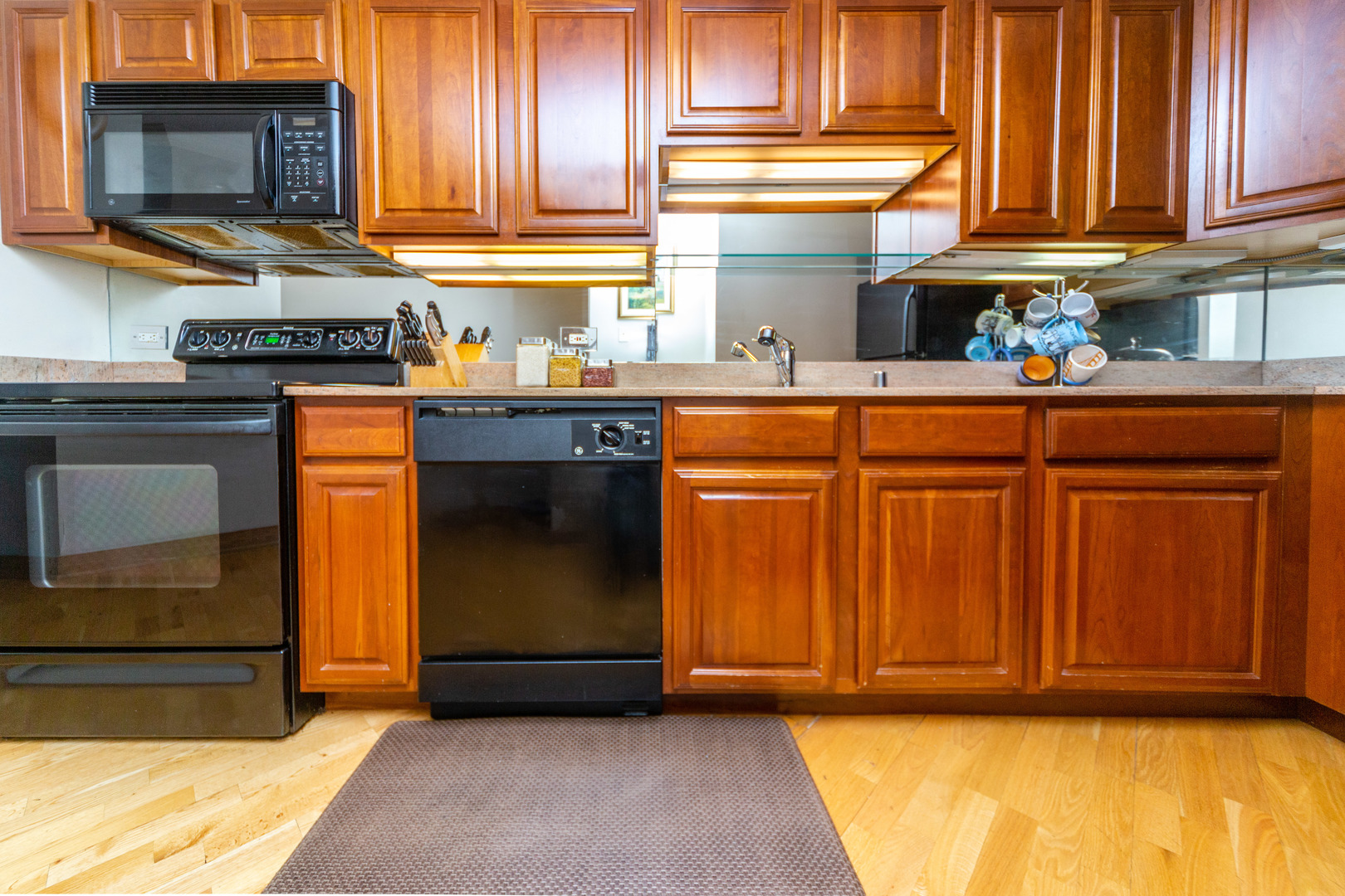 5320 North Sheridan Road, Unit 802 Chicago, IL 60640 - Photo 9 of 26 a kitchen with stainless steel appliances granite countertop a refrigerator and a sink