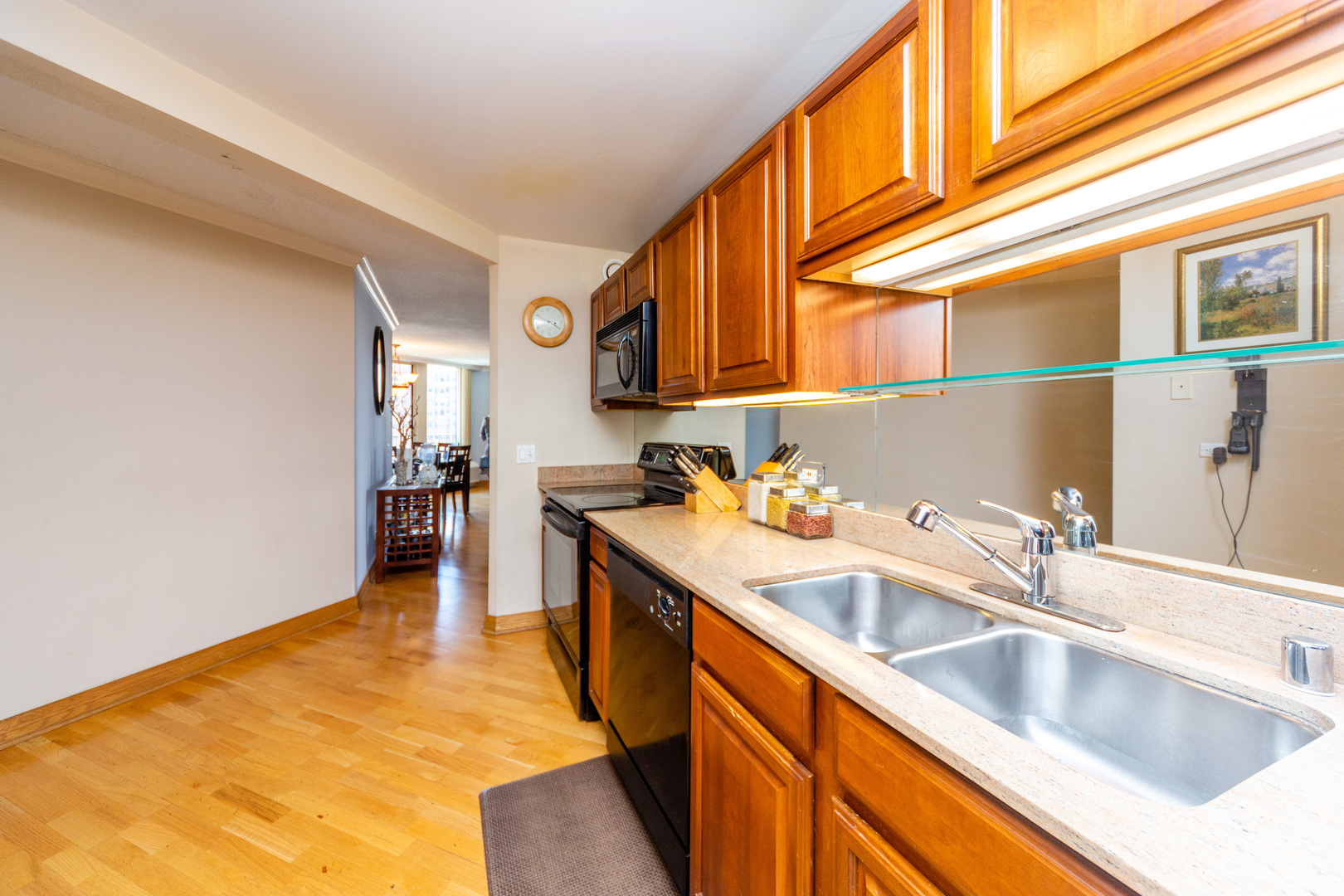 5320 North Sheridan Road, Unit 802 Chicago, IL 60640 - Photo 10 of 26 a kitchen with stainless steel appliances granite countertop a sink and cabinets