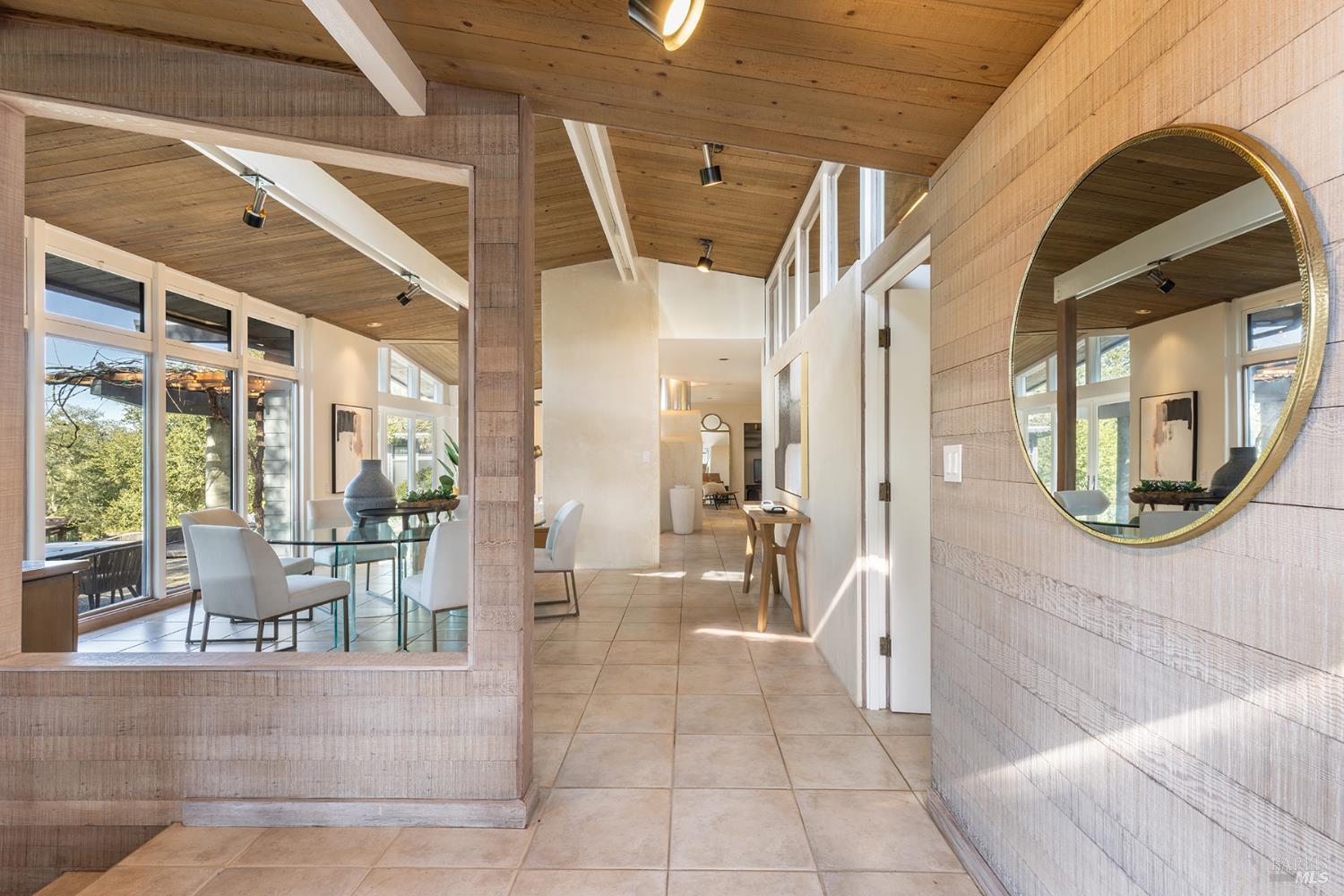 5815 Bennett Valley Road Santa Rosa, CA 95404 - Photo 9 of 50 a view of a hallway with dining area and glass windows