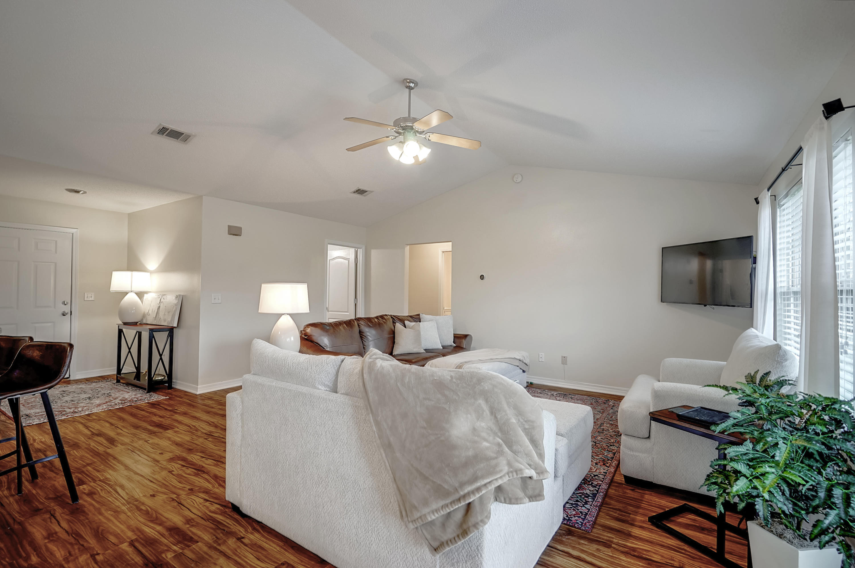 5145 Eagle Way Crestview, FL 32539 - Photo 5 of 15 a living room with furniture a lamp and a flat screen tv