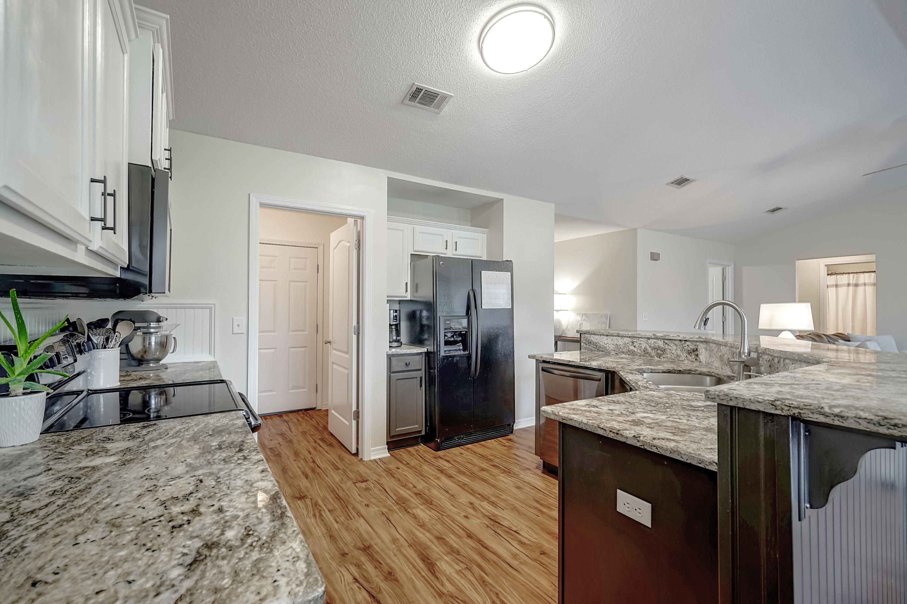 5145 Eagle Way Crestview, FL 32539 - Photo 7 of 15 a kitchen with stainless steel appliances granite countertop a sink stove and refrigerator
