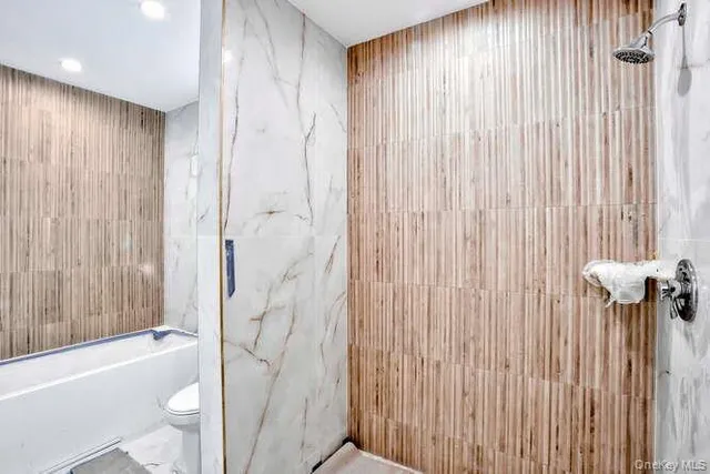 a bathroom with a shower curtain and a toilet