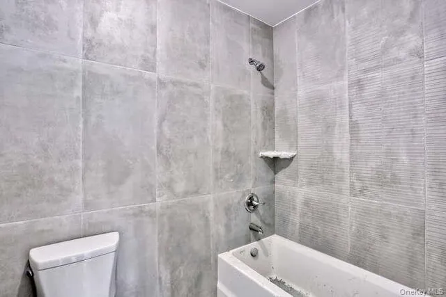 a bathroom with a toilet sink and shower