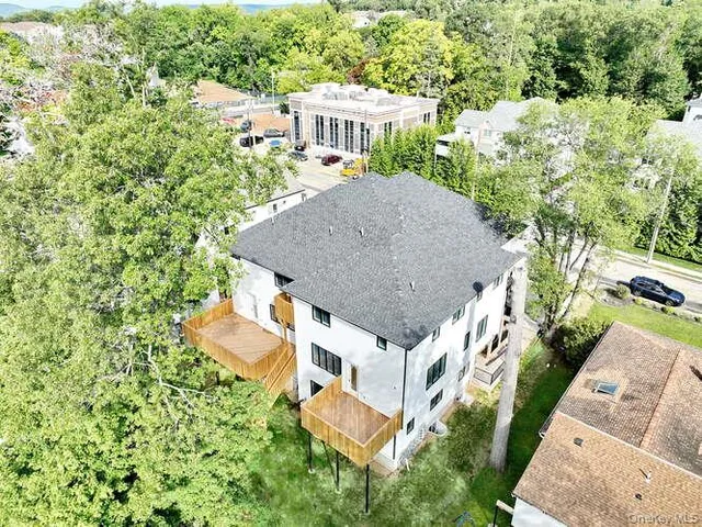 an aerial view of a house with a yard and trees