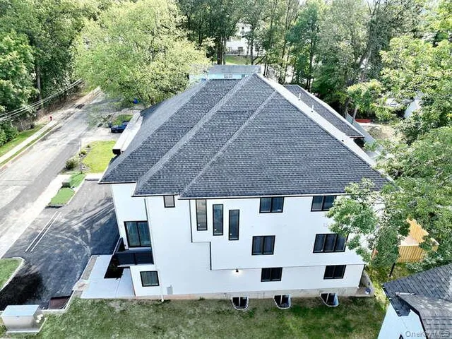 a white house with tall tree in front of it