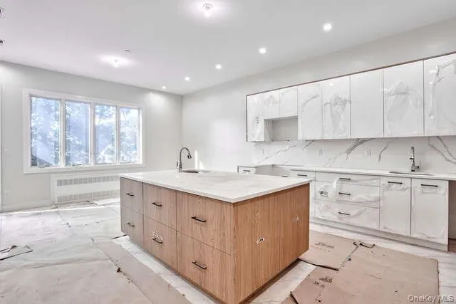 a kitchen with a sink window and cabinets